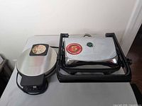 Closed view of both appliances showing exterior stainless steel lids and size comparison