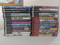 Front spines of all 28 PS2 game cases stacked in two columns