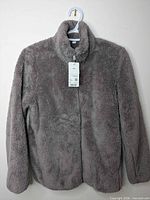 Front view of brown Uniqlo fluffy yarn fleece jacket with tags attached