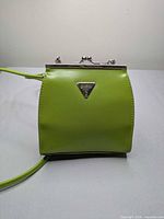 front view showing Guess logo and purse color