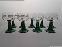 Nine green stemmed glasses front and angled view
