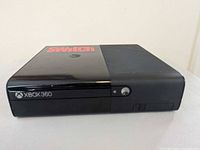 Front and top view of Xbox 360 E console showing overall condition and red Switch decal