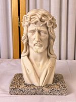 Front view of alabaster bust on stone base