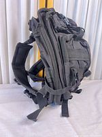 Side view showing overall pack profile, MOLLE webbing and shoulder straps