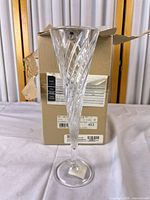 One crystal flute displayed in front of the original box