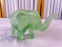 Left side view of frosted green glass elephant showing overall form