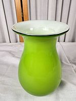 Full view of lime green glass vase showing bulbous body and flared mouth