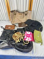 Group shot of all eight bags and wallet on table