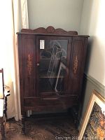 Front view of closed cabinet showing overall appearance and decorative details