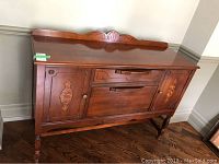 Front elevation of sideboard with cabinet doors and drawers closed