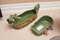 Both ceramic planters together showing the dragon planter and the fish-accented planter