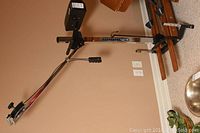 Full view of the NordicTrack exercise machine showing metal frame, foot pedals, and handlebar against beige wall.