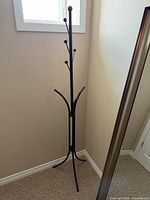 full view of black metal coat rack