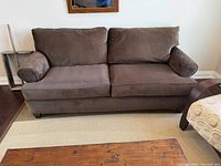 front view of brown corduroy sofa showing cushions and arms