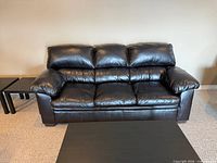 Front view of dark brown bonded leather sofa