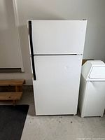 Front view of white Kenmore top-freezer refrigerator showing overall appearance