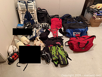 Overview of lot showing goalie pads, bags, protective gear and accessories