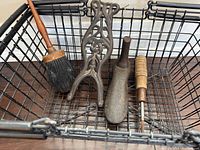Brush, ornate cast iron stand, shoe last, awl in wire basket