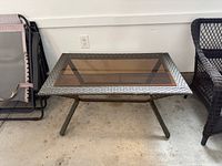 Full view of wicker coffee table, glass top