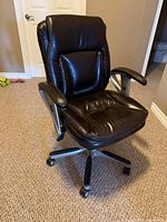 Front angled view of brown leather Serta office chair, shows overall design