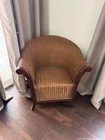 Front angled view of wicker armchair showing overall design and condition