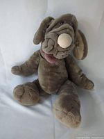 Full view of Wrinkles plush dog puppet seated