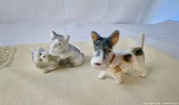 Front view of both porcelain dog figurines