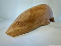 Profile view of entire wooden seal figurine