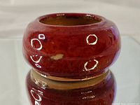 Side profile showing red glaze and overall shape