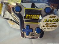 Close-up of front controller inside package showing buttons and promotional sticker