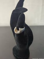 Front view of sterling silver horseshoe ring on display stand