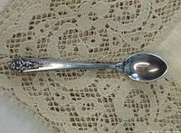 Front view of ornate sterling miniature spoon brooch