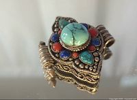 Front angled view showing stone layout and metalwork