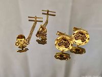 Set laid out showing two tie tacks and two cufflinks