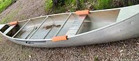 Canoe right-side up showing interior, seats, thwarts and orange gunnel pads