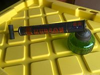 Side view of Hudson pump sprayer on yellow surface