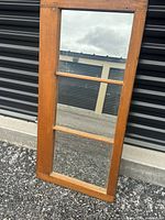 Full view of antique window mirror leaning against wall