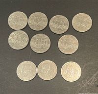 All ten coins laid out showing reverse designs