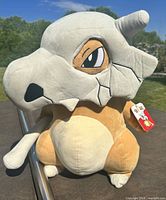 Front view of Cubone plush showing overall appearance and attached tag