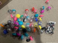 Pile of empty multi-colour vending capsules and bag of loose Homies figures