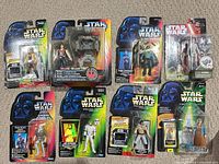 All eight carded figures laid out