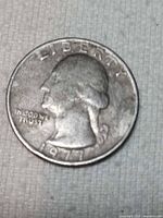 Obverse view showing date 1977, LIBERTY, IN GOD WE TRUST, off-center strike