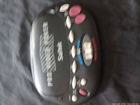 Closed handheld poker game showing exterior branding and overall color