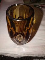 Front view showing amber color, thick walls, polished rim