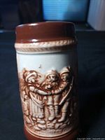 Front showing embossed three-figure scene