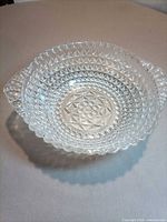 Top view of clear pressed glass bowl showing overall pattern and handles