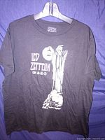 Full front view of T-shirt on hanger