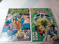 Both comic books side by side in protective bags