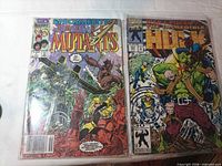 Front covers of both bagged comics