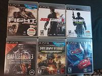 Front view of six PS3 game cases arranged in two rows